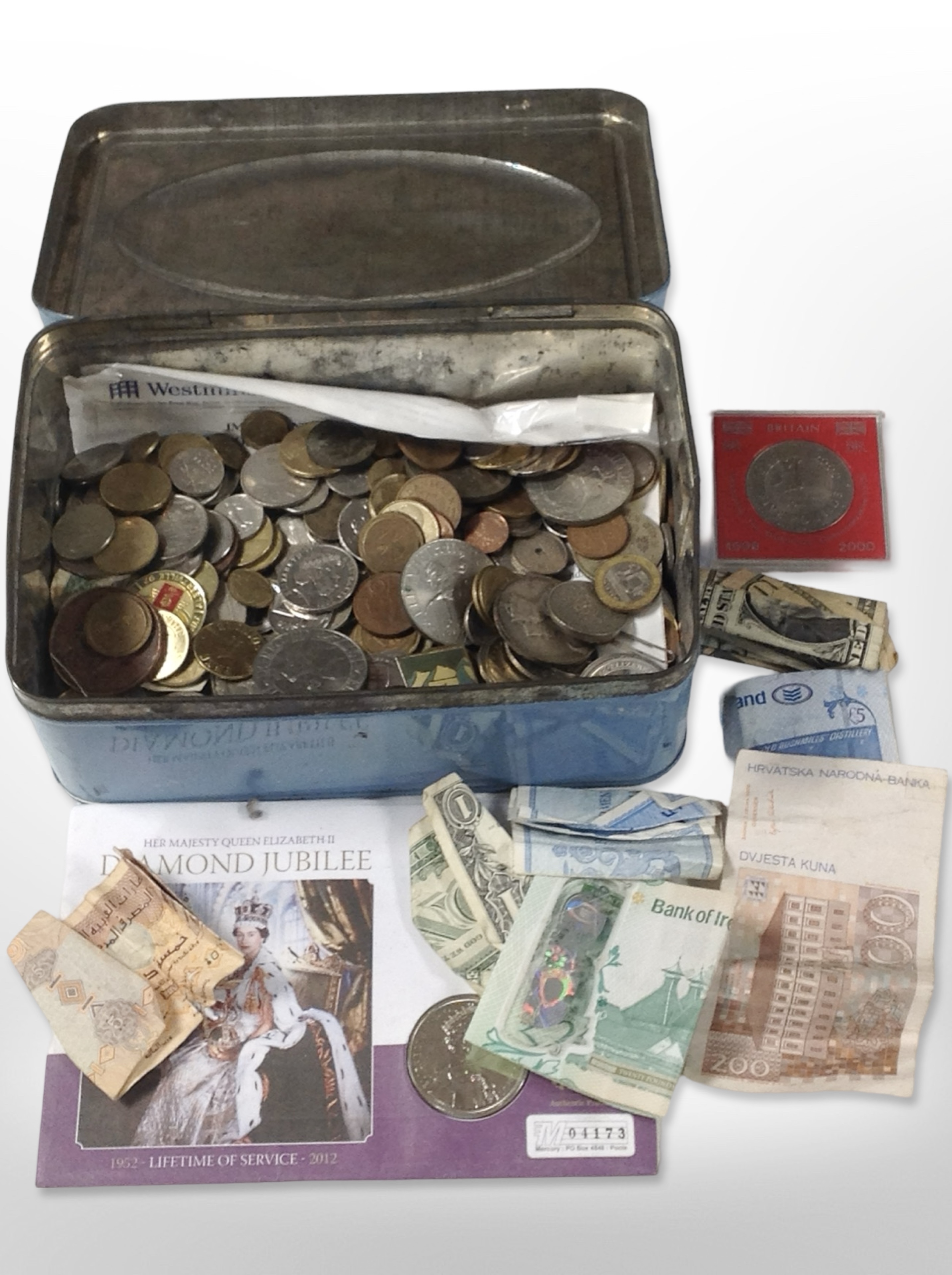 A tin of mixed British coins, crowns, foreign bank notes, etc.