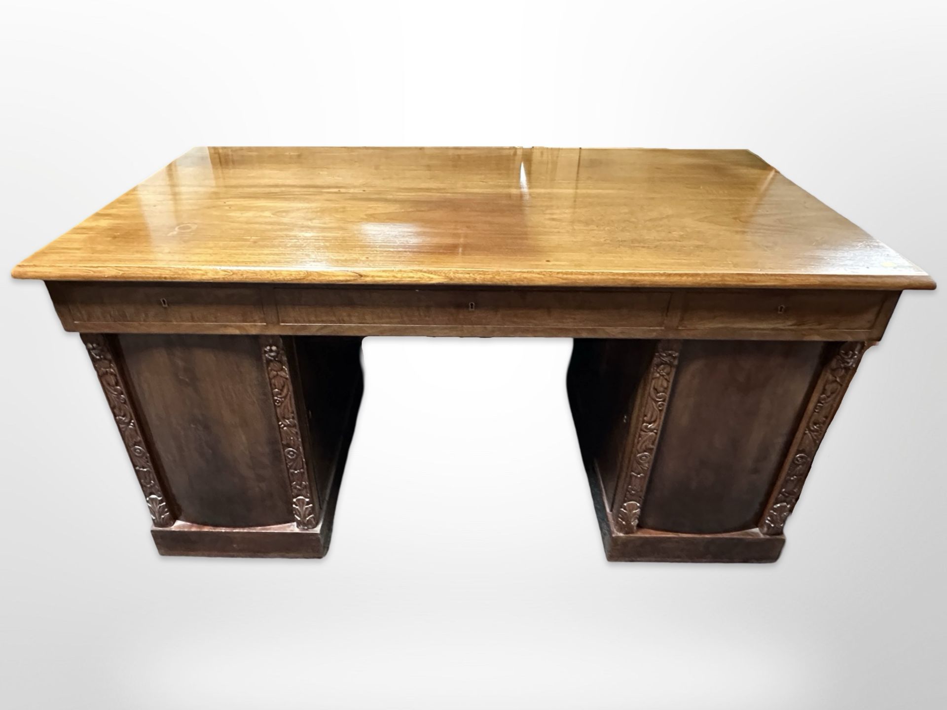 An early 20th century Continental walnut twin pedestal writing desk,