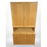 A late 20th century Danish oak veneered cabinet with cupboards beneath and above,