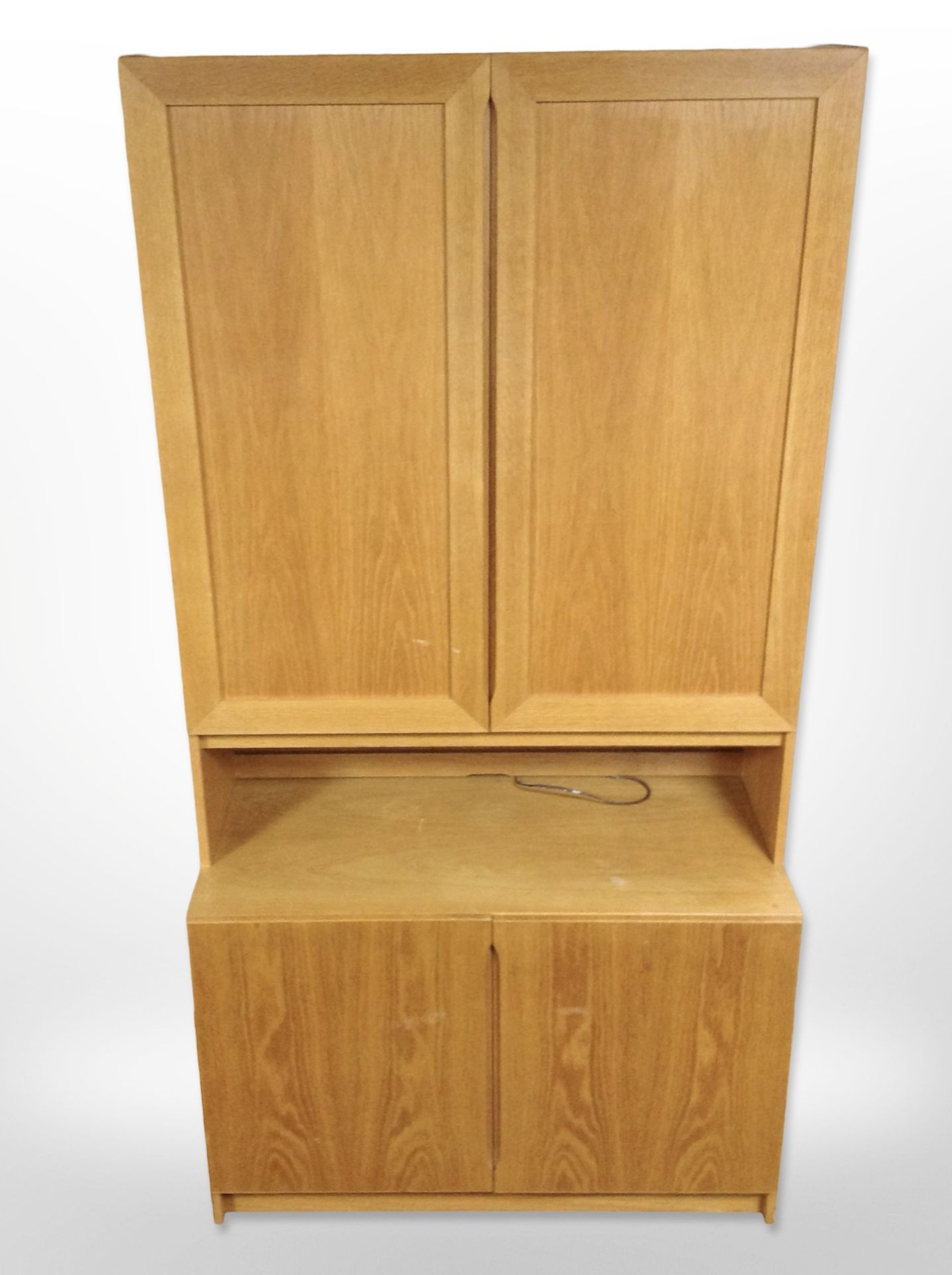 A late 20th century Danish oak veneered cabinet with cupboards beneath and above,