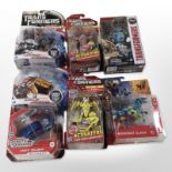 Seven Hasbro Transformers figurines, boxed.