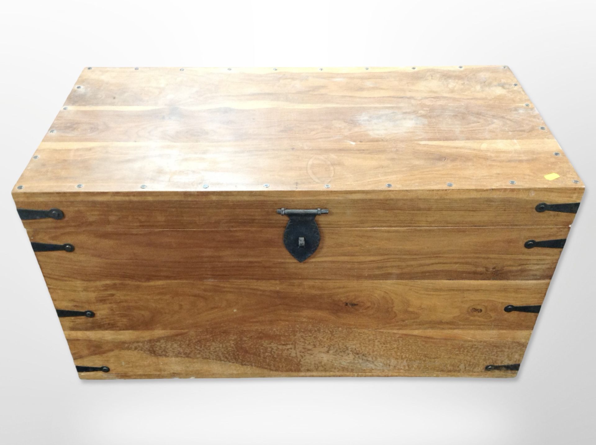 A mango wood blanket chest with metal mounts,