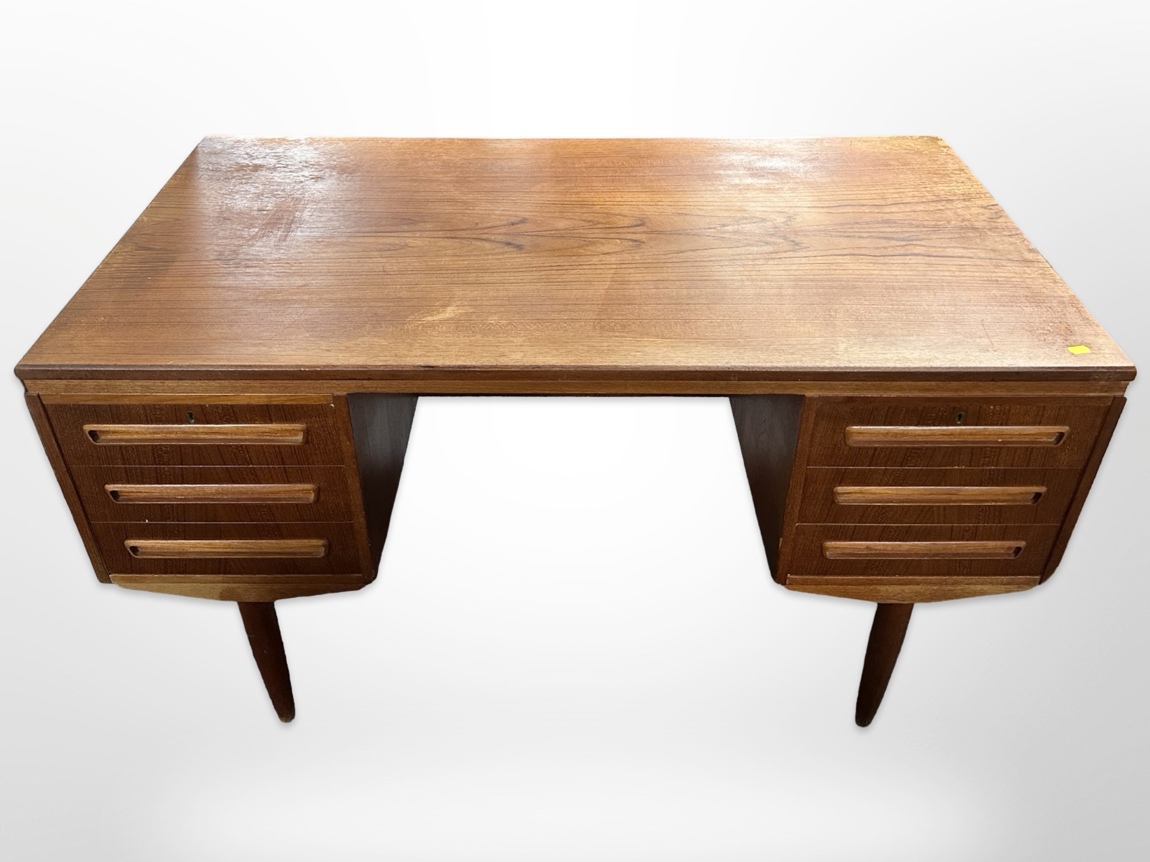 A 20th century Danish teak double sided twin-pedestal writing desk on tapered legs,
