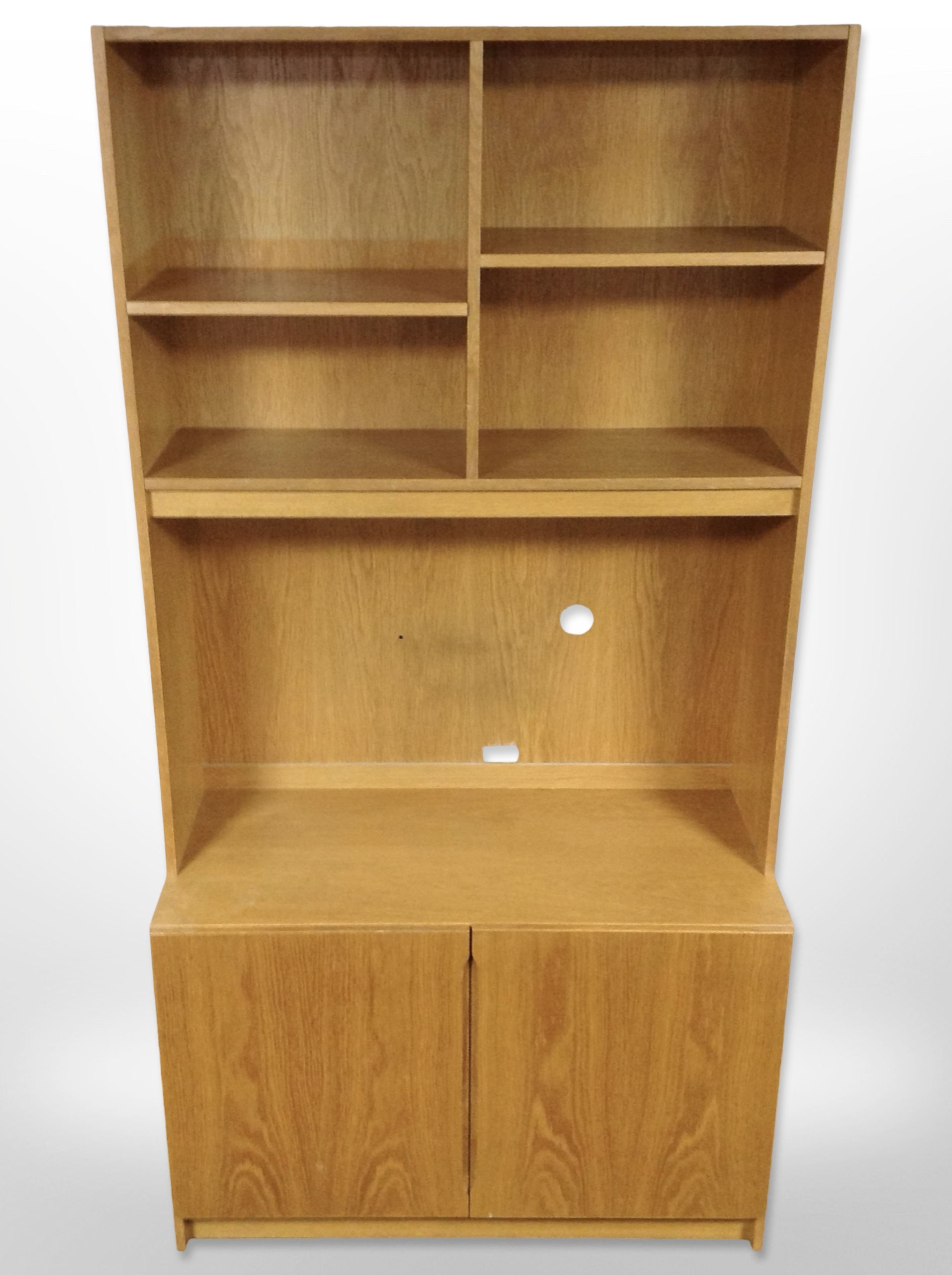 A late 20th century Danish oak veneered open bookcase with cupboards beneath,