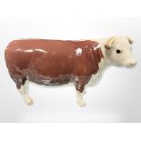 A Beswick cow, 'Ch. of Champions', length 16.5cm.