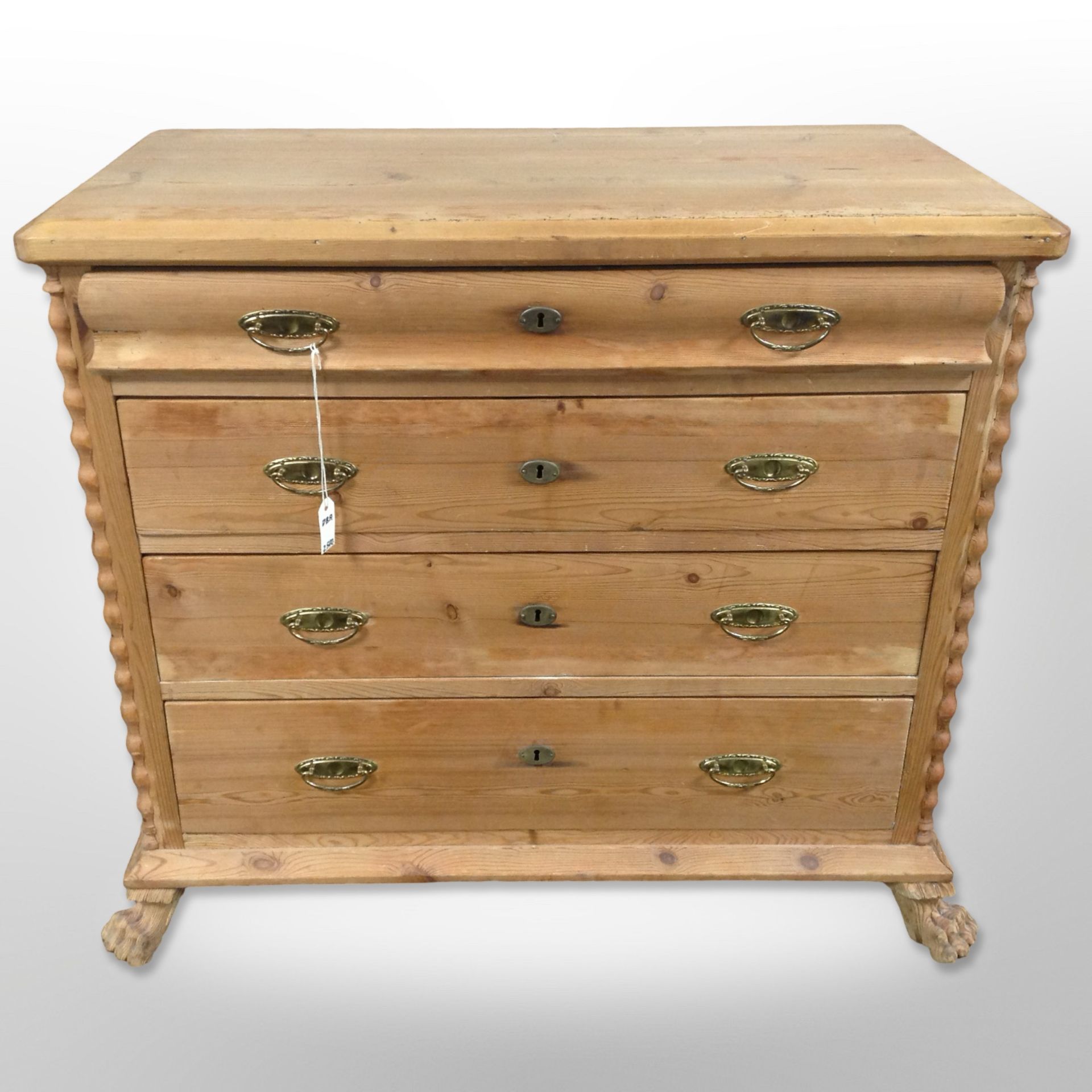 A 19th century Scandinavian pine chest of four drawers, raised on lion paw feet,