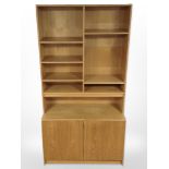 A late 20th century Danish oak veneered open bookcase with cupboards beneath,