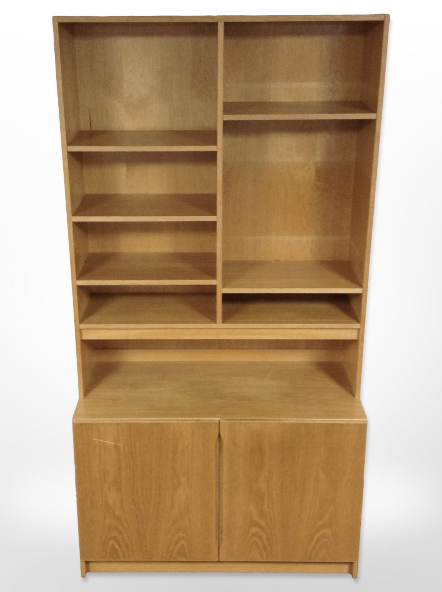 A late 20th century Danish oak veneered open bookcase with cupboards beneath,