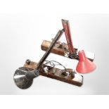 Two vintage anglepoise lamps mounted on wood working planes,