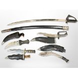 An Indian sabre in scabbard with 73cm blade, together with two further Indian-made kukris,