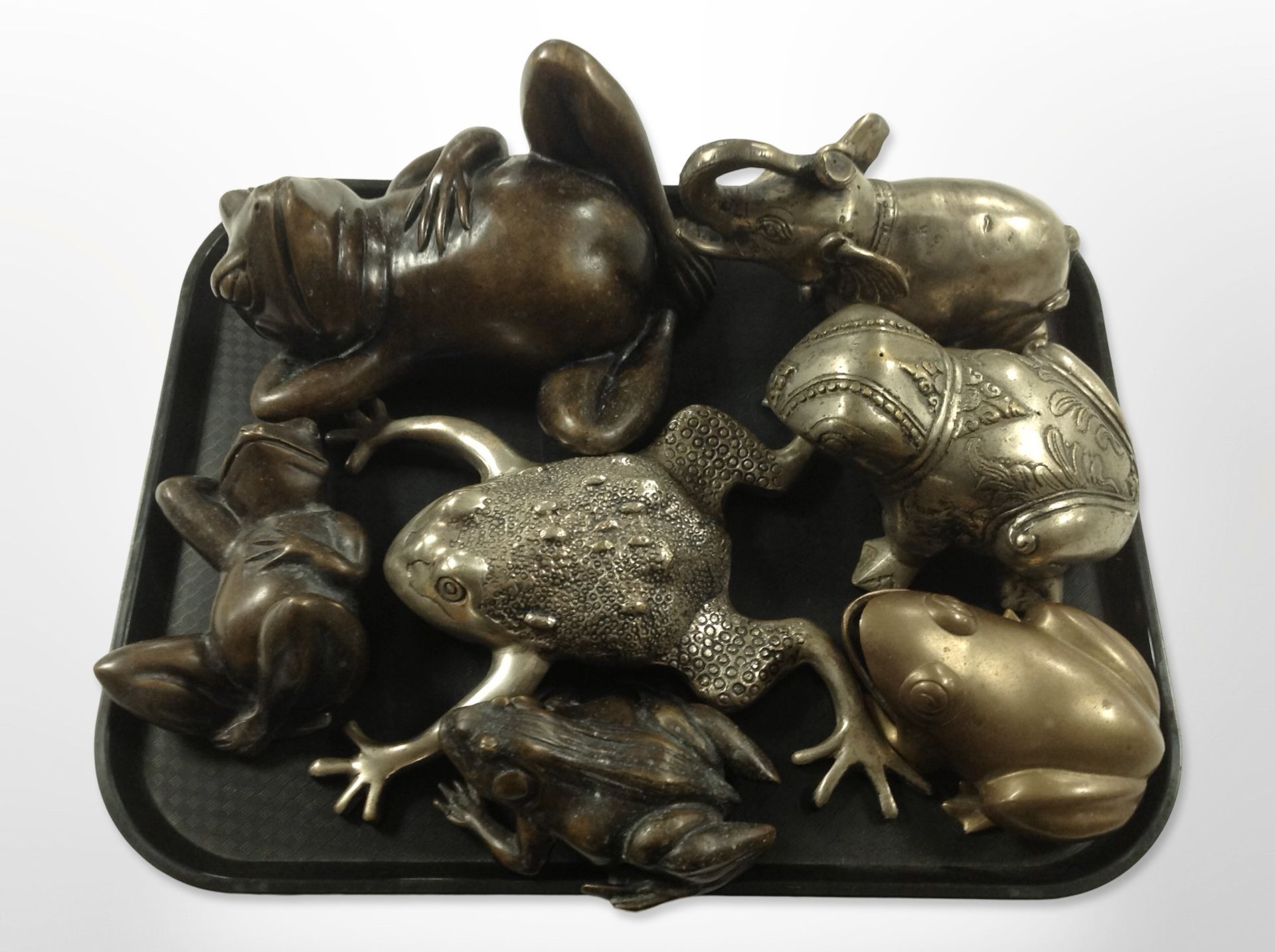 A group of cast-bronze frog ornaments,