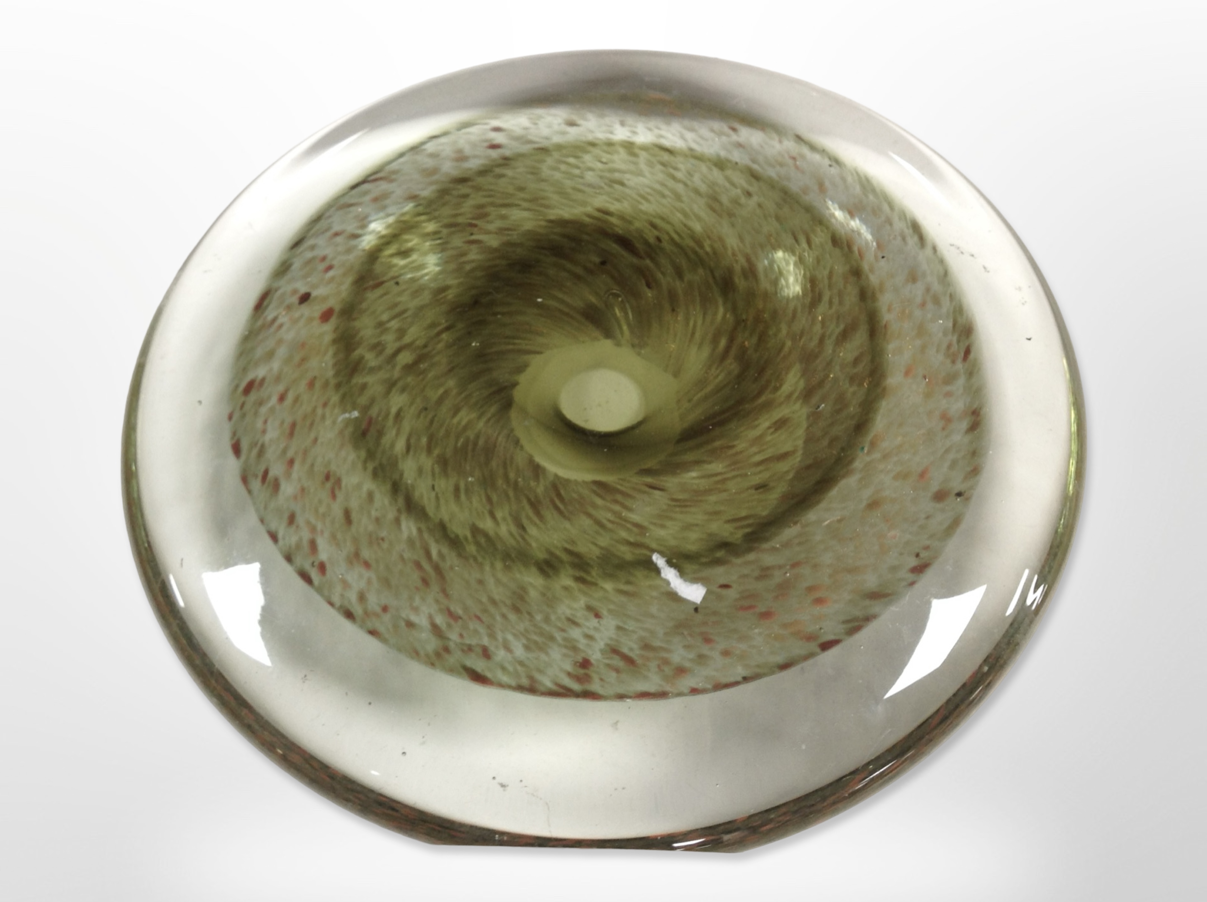 An art glass discus-form sculpture, diameter 22cm, with flat standing edge on one side.