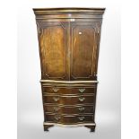 A reproduction mahogany serpentine front drink's cabinet,