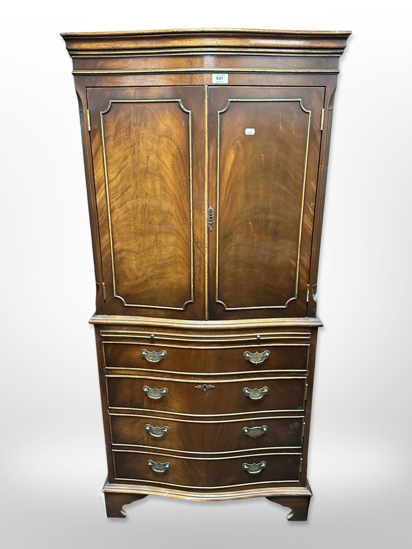 A reproduction mahogany serpentine front drink's cabinet,