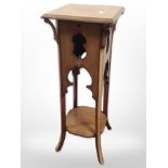 An early 20th century inlaid mahogany plant stand,