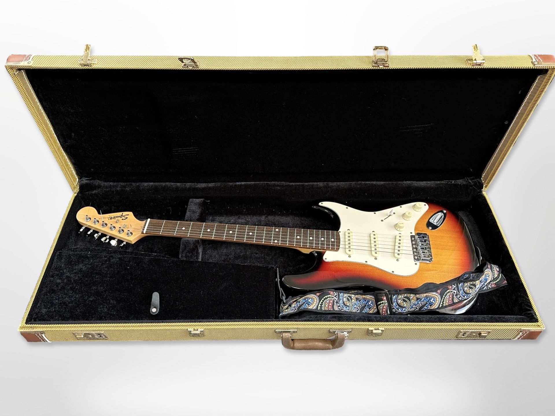 A Squire by Fender electric strat guitar, in fitted Rockcase,