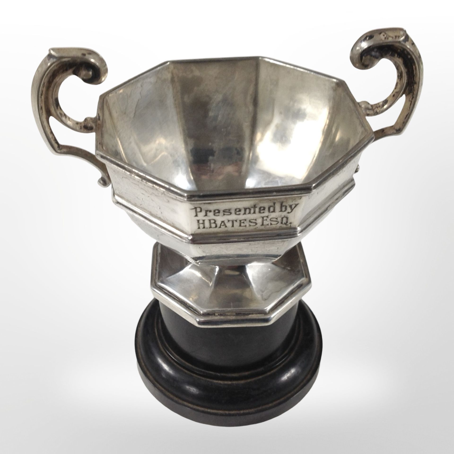 A small silver trophy cup by Walker and Hall, Sheffield marks, on pedestal, height 10cm.
