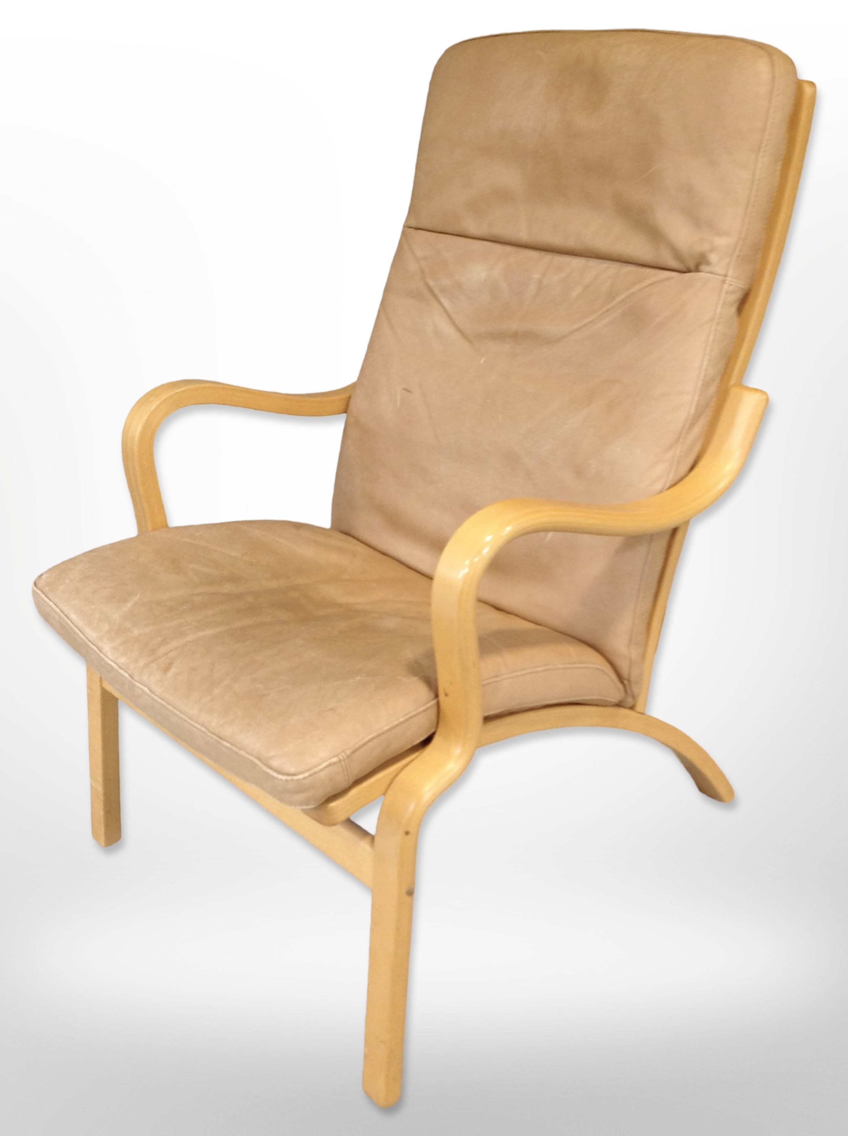 A contemporary Scandinavian laminated beech bentwood armchair with tan leather seat,