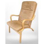 A contemporary Scandinavian laminated beech bentwood armchair with tan leather seat,