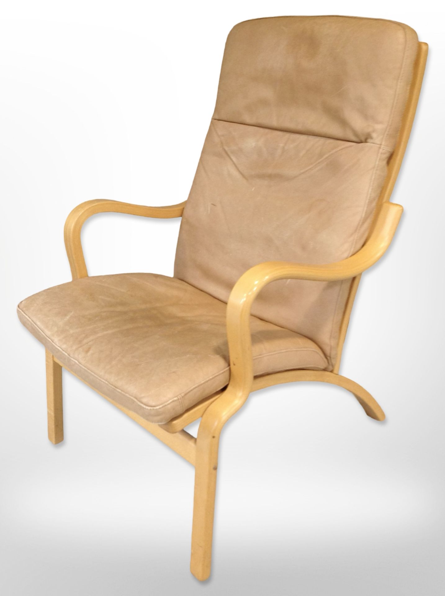 A contemporary Scandinavian laminated beech bentwood armchair with tan leather seat,