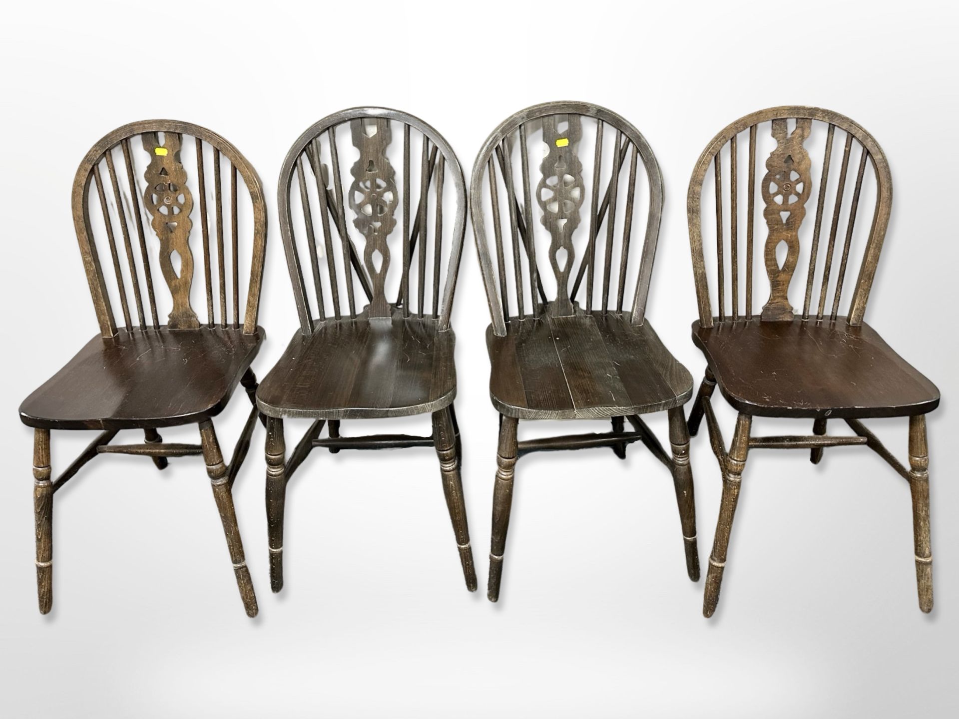 Two pairs of oak wheel back dining chairs