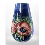 A Moorcroft bulbous vase on dark blue ground, height 18.5cm.