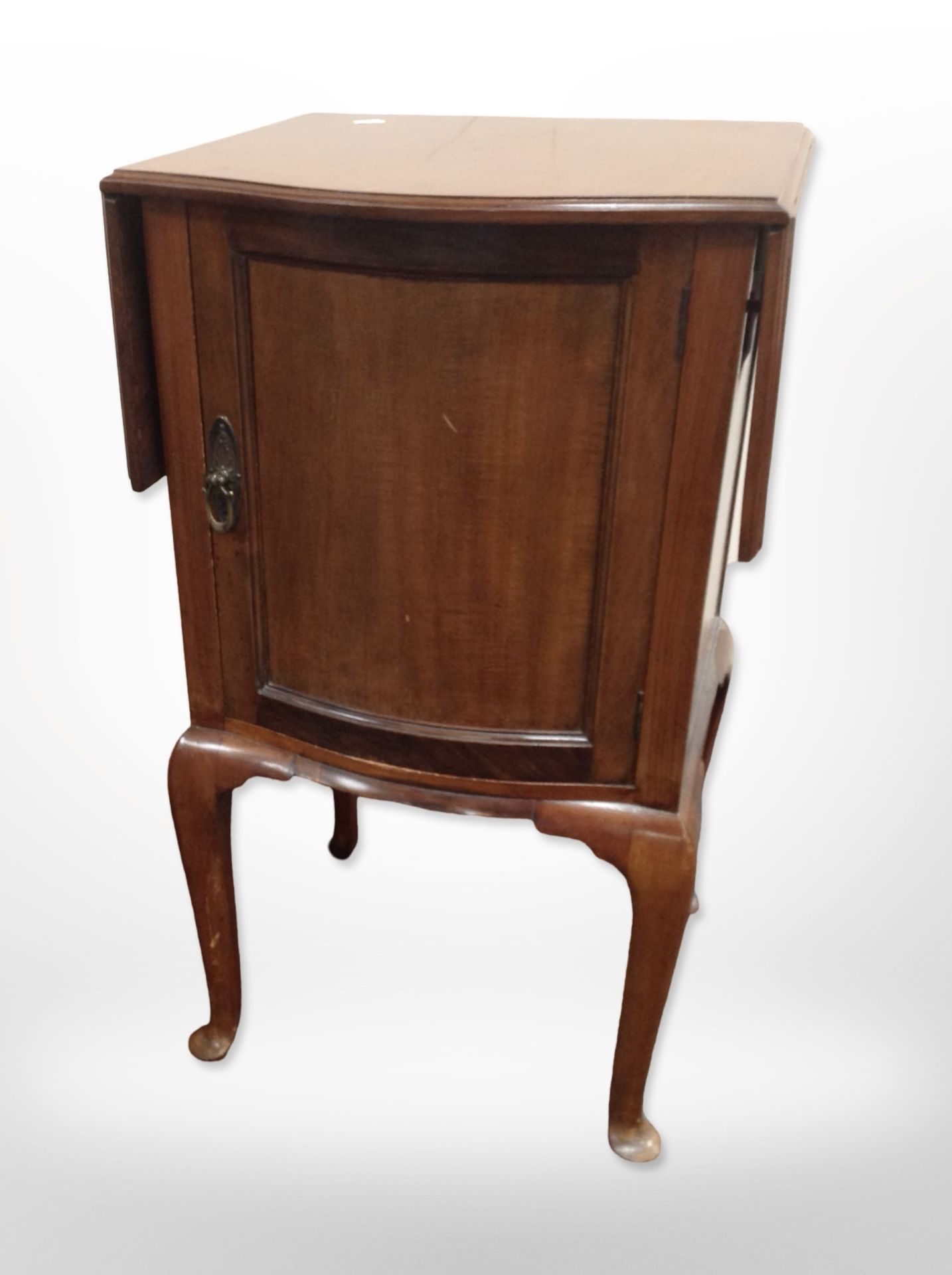 An early 20th century mahogany drop leaf pot cupboard,