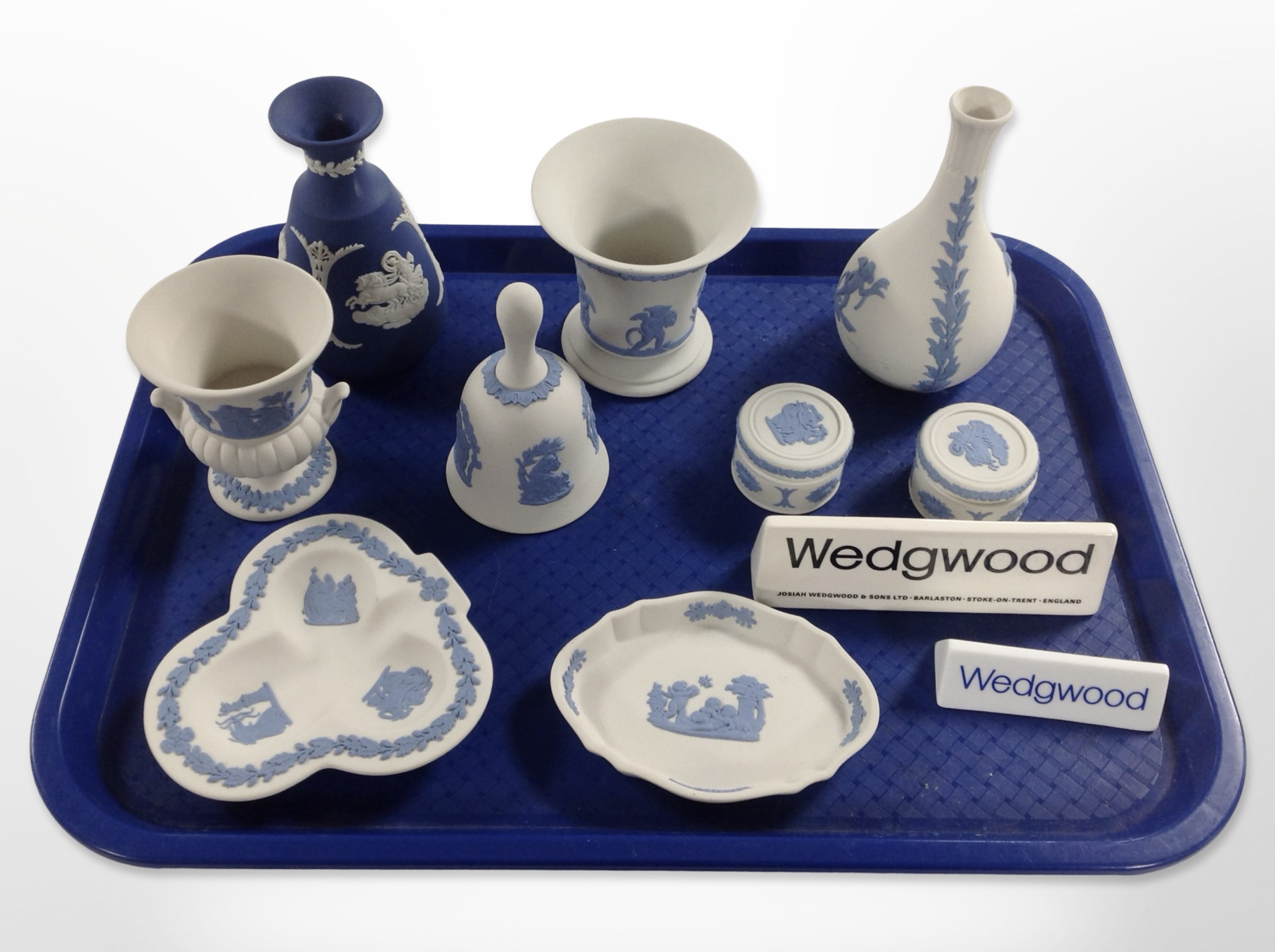 A group of Wedgwood blue and white Jasperware including vases, urns, dishes, two Wedgwood plaques.