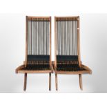 A pair of contemporary teak framed folding chairs with rope seats,