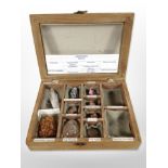 A glazed collector's case containing geology and crystal specimens, 30cm wide.