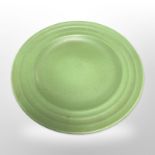 A Keith Murray for Wedgwood green-glazed plate with ribbed edge, diameter 26cm.