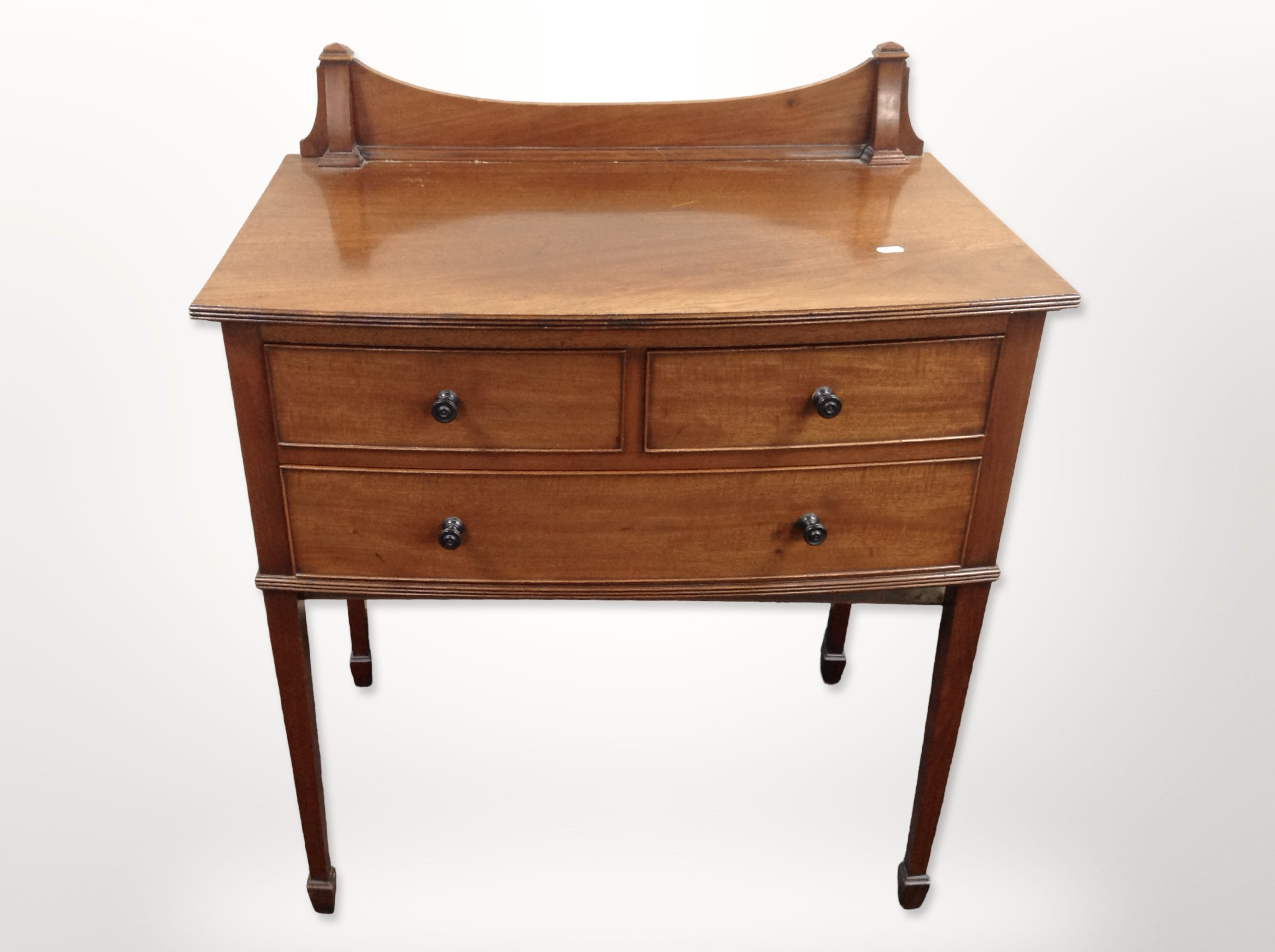 An early 20th century mahogany bow-front wash stand fitted three drawers,