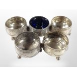 A group of five silver salts, one with blue-glass liner, together with a small silver napkin ring.