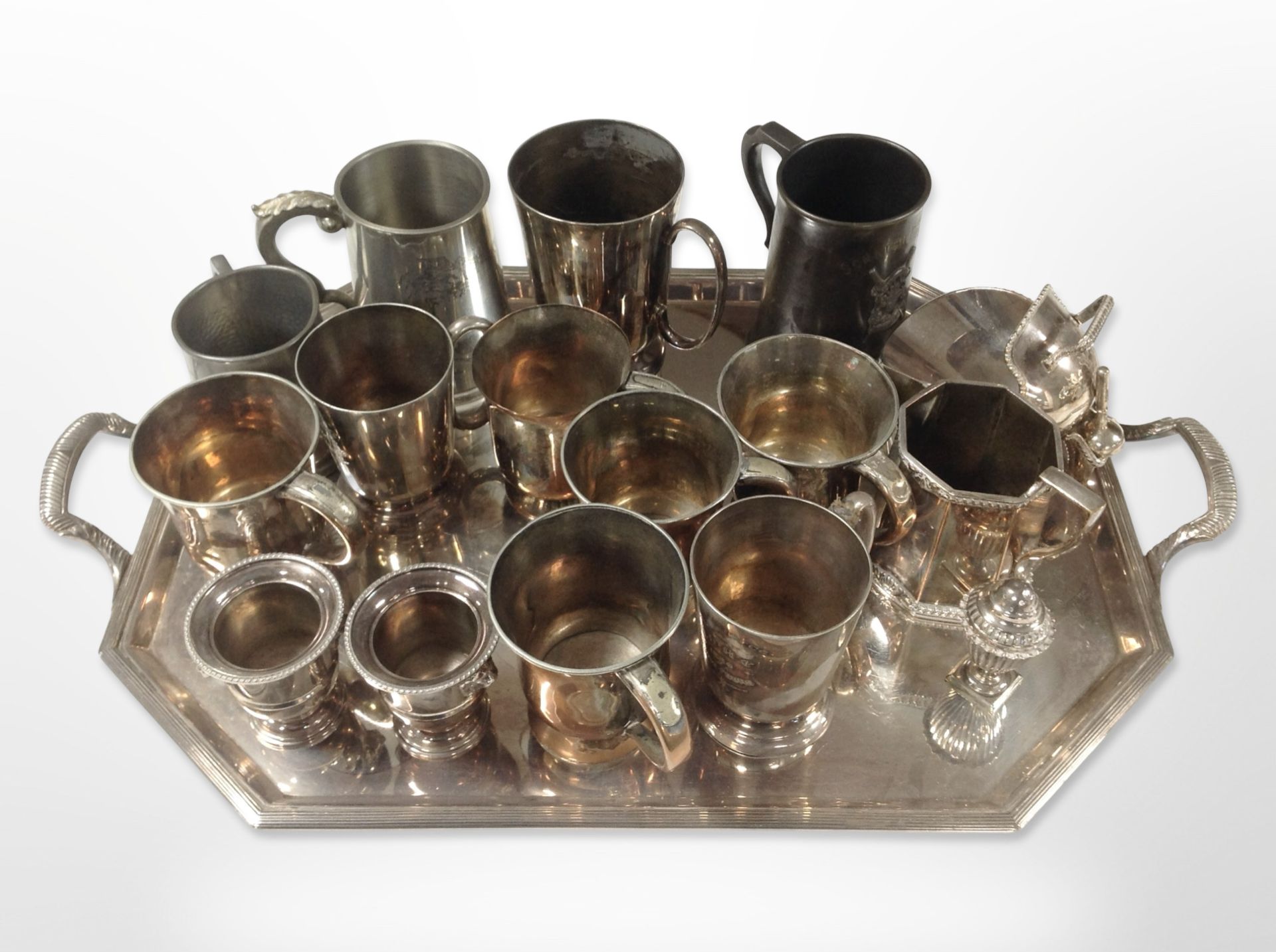 A silver plated octagonal serving tray containing assorted mugs and tankards, coal scuttle,