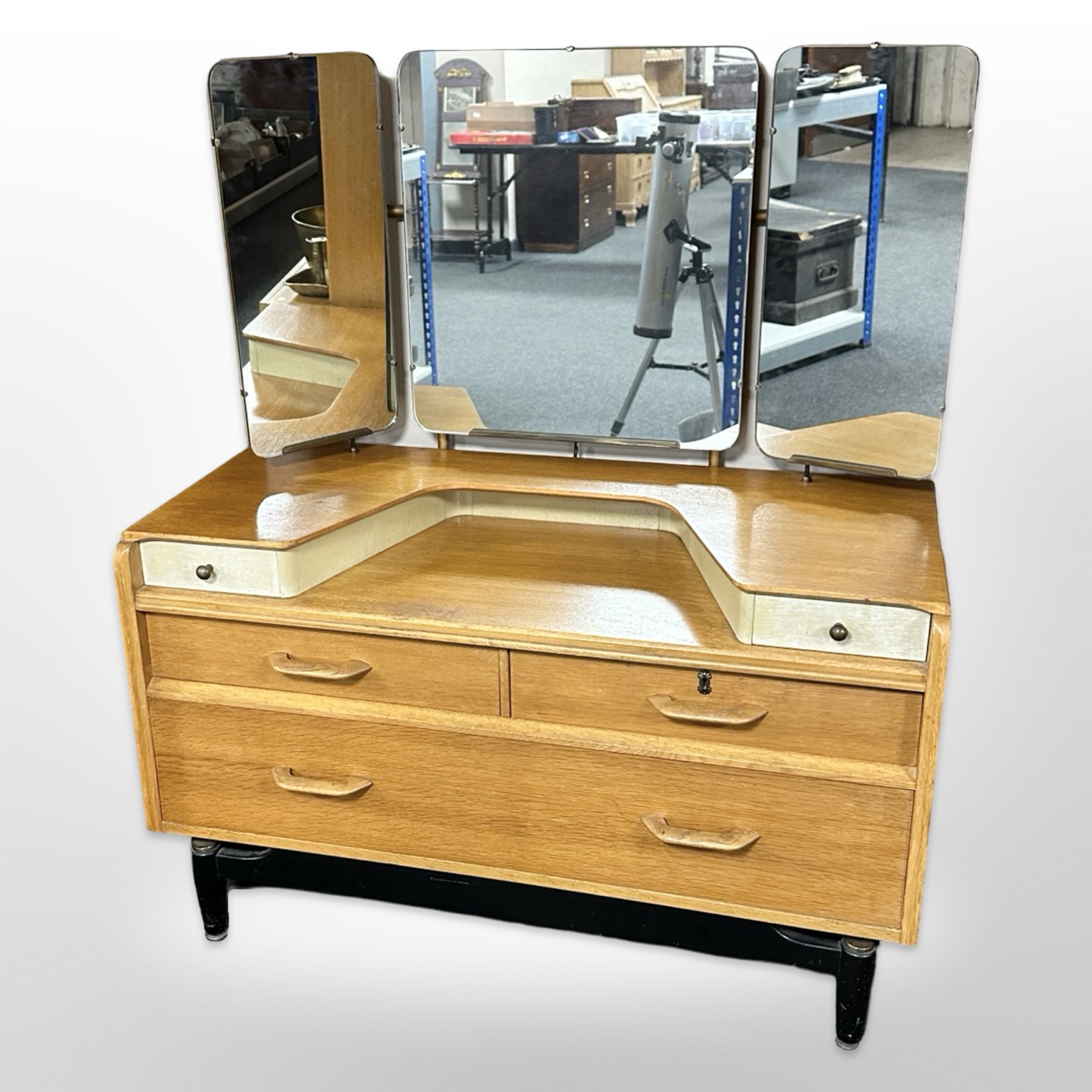 A vintage G Plan oak and teak sunk-centre dressing table with triple mirror back,