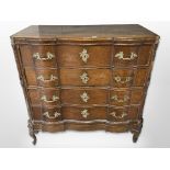 A 19th century Scandinavian oak serpentine fronted chest of four drawers,