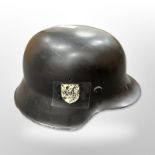 A World War II German M35 Stahlhelm steel helmet with SS decal and Swastika decal to opposing side,