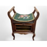 A late Victorian mahogany storage piano stool,