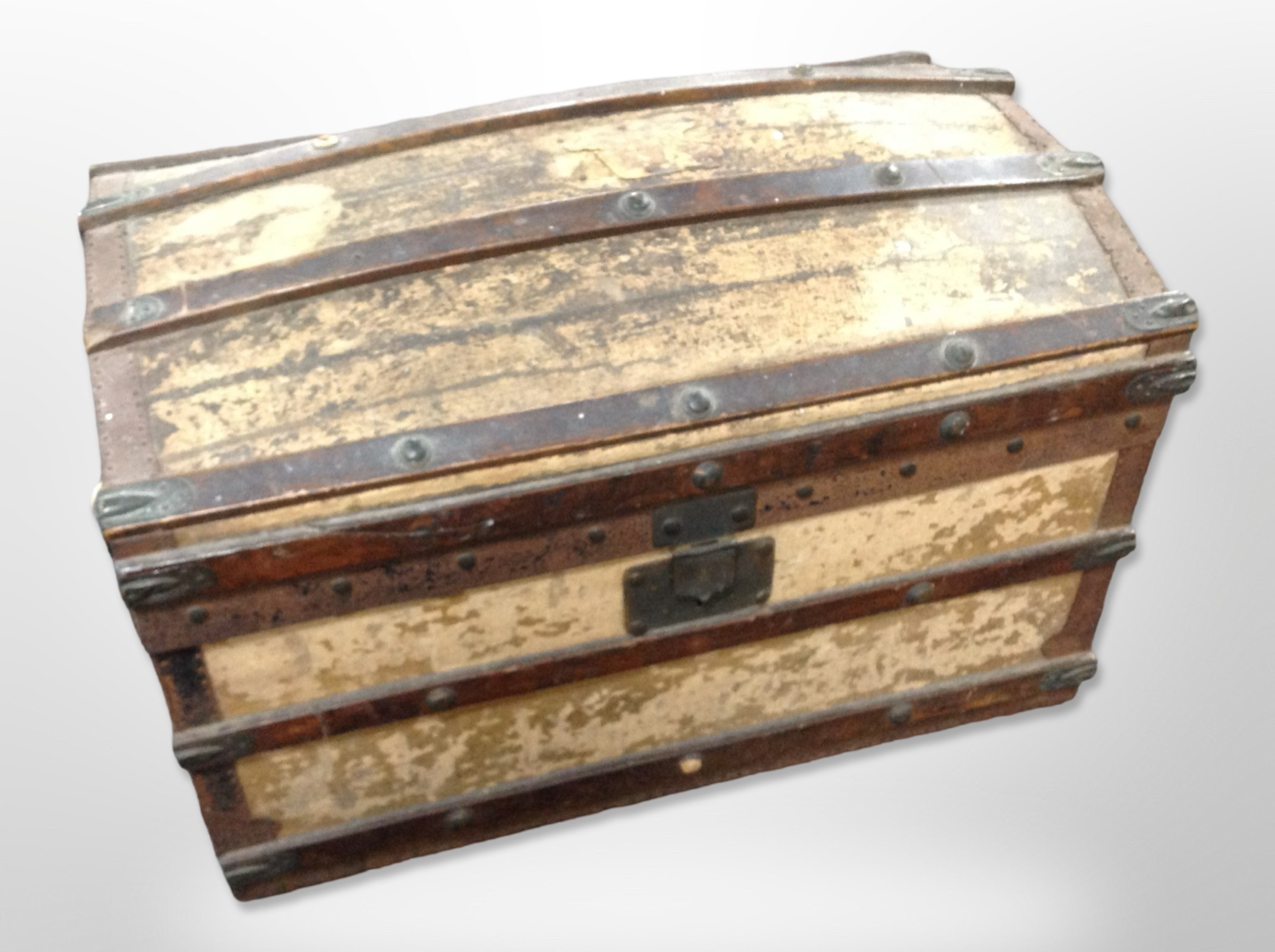 A 19th century canvas and wooden bound domed top trunk,