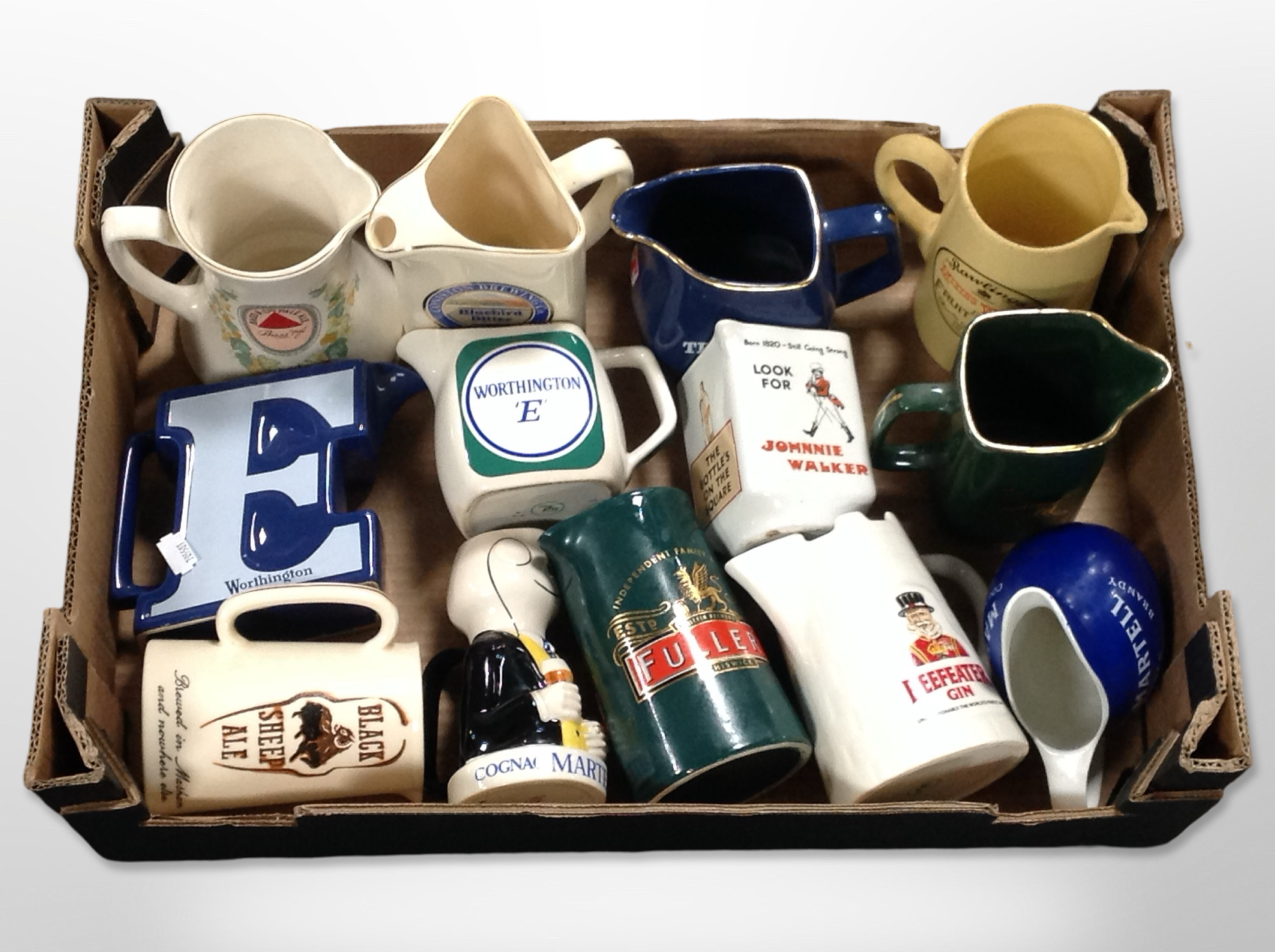 A collection of ceramic whisky jugs bearing various advertising.