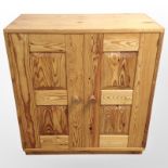 A contemporary pine double door cupboard,