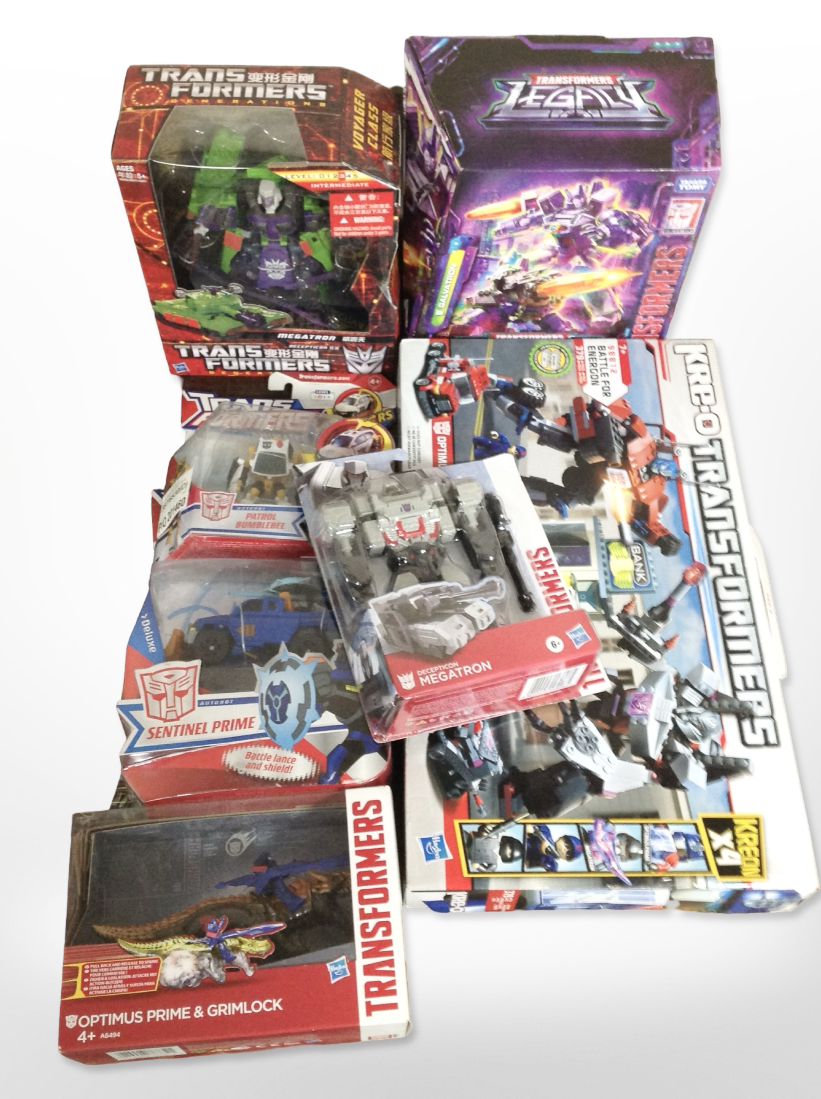 Seven Hasbro and Tomy Transformers figurines, boxed.
