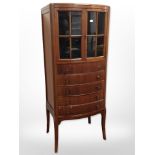 A reproduction mahogany bow-front cabinet,