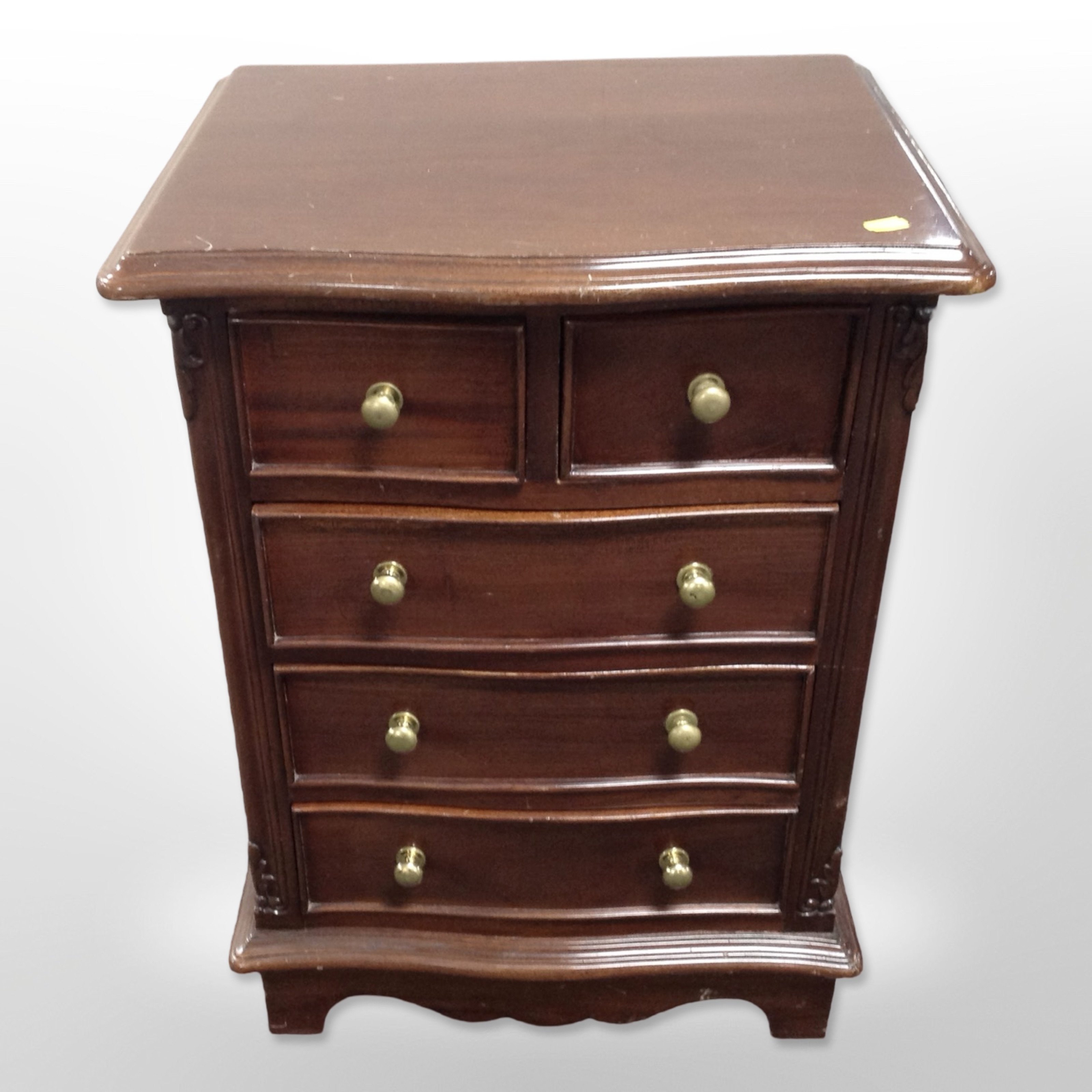 A reproduction mahogany serpentine fronted five drawer chest,