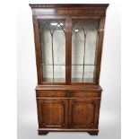 A reproduction mahogany bookcase in George III style, with internal glass shelves,