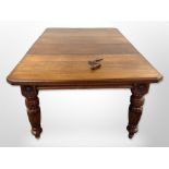 A good quality Edwardian carved oak extending dining table with two leaves and winder,