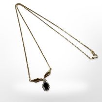 A 9ct yellow gold sapphire and diamond pendant suspended on gold plated chain