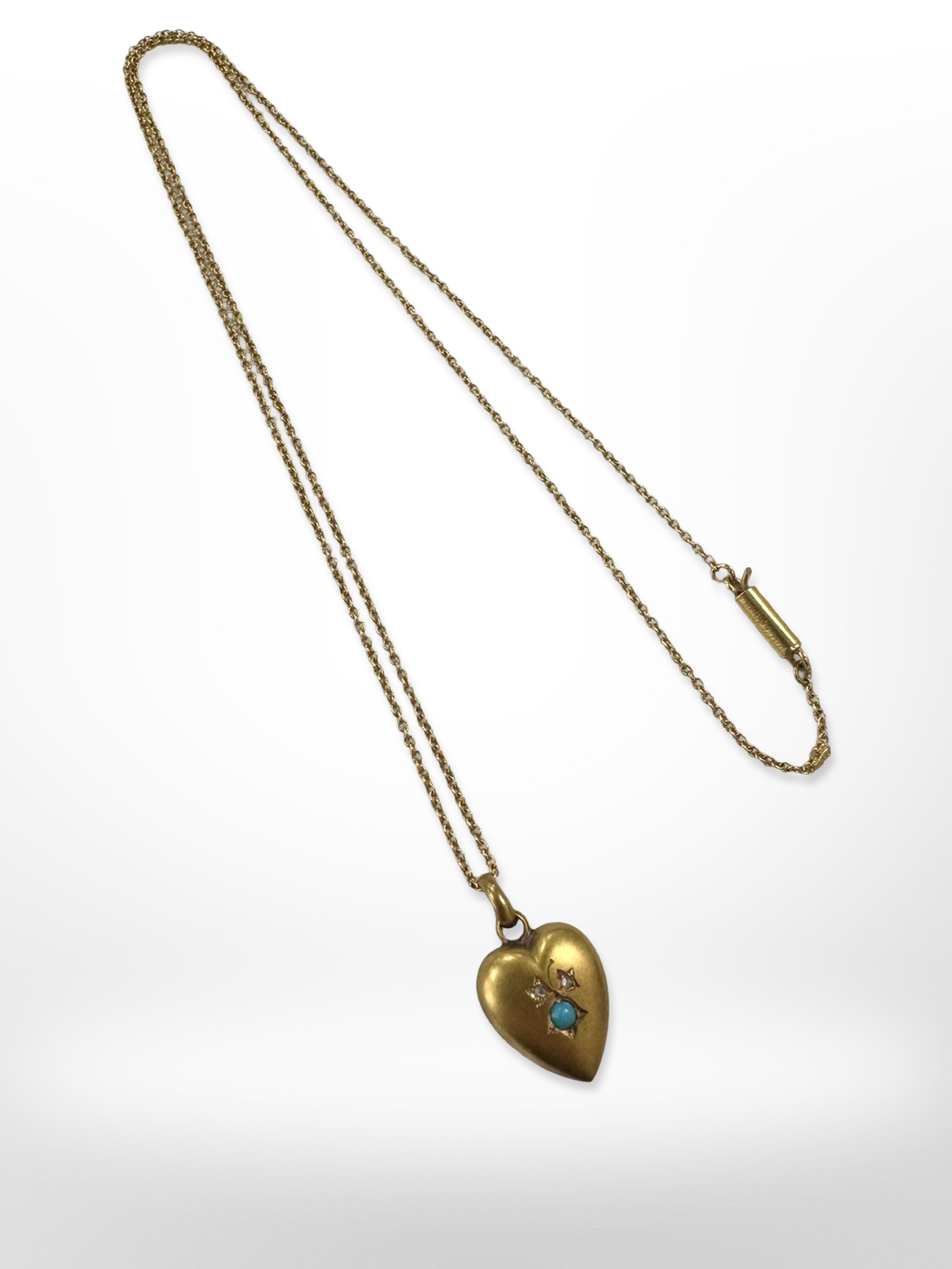 An antique 15ct gold heart-shaped pendant on yellow gold chain. CONDITION REPORT: 2.