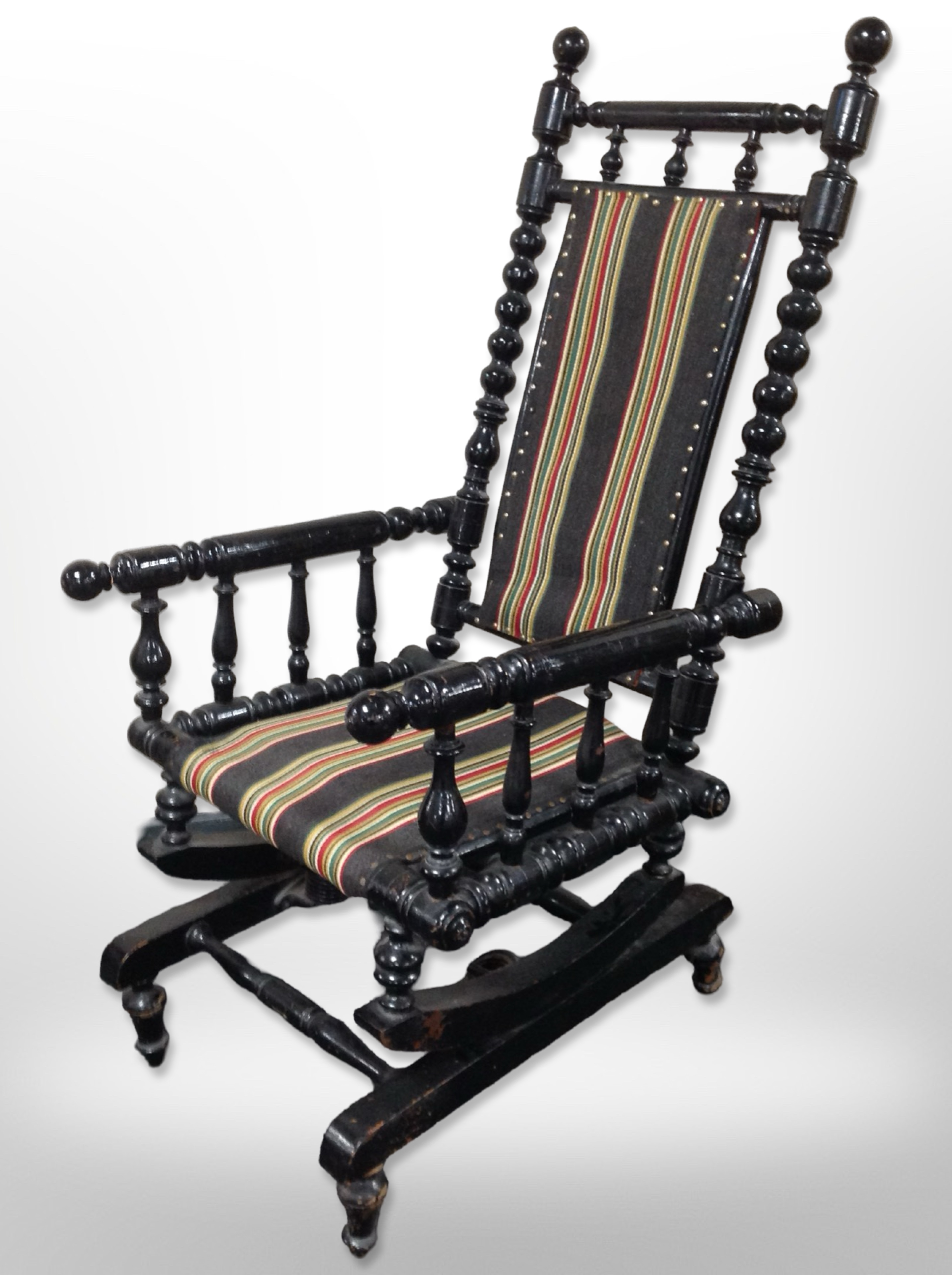 A 20th century Scandinavian bobbin turned ebonised rocking chair