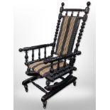 A 20th century Scandinavian bobbin turned ebonised rocking chair